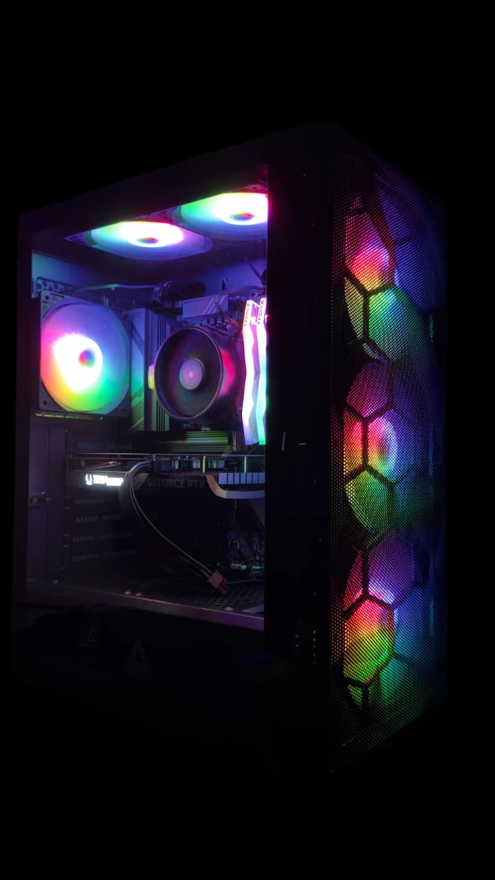 M1 completed gaming PC build with an AMD Ryzen 5 8600G and NVIDIA RTX 4060, black case with multicolor ARGB fan lighting.