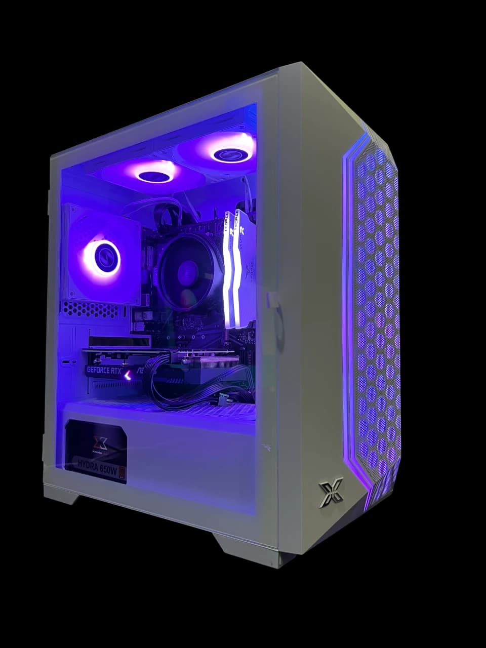 M1 completed gaming PC build with an AMD Ryzen 5 5600X and NVIDIA RTX 3060, all-white case with blue-purple ARGB fan lighting.